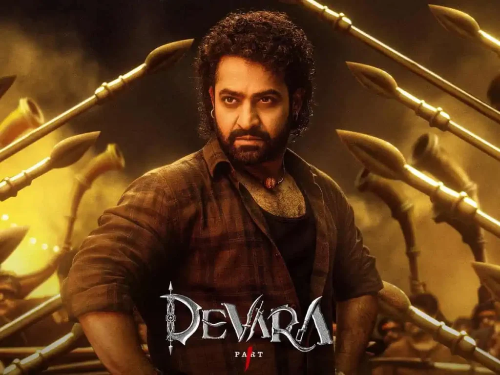 a man standing in front of a group of gold spears scene of upcoming south movie devara