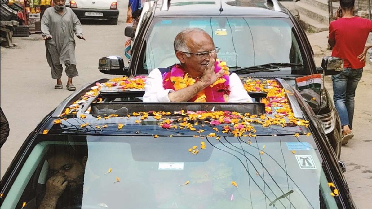 a man in a car with flowers on the hood